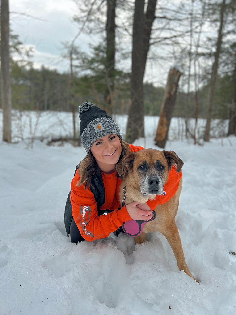 Woman with Dog in Snowy Forest