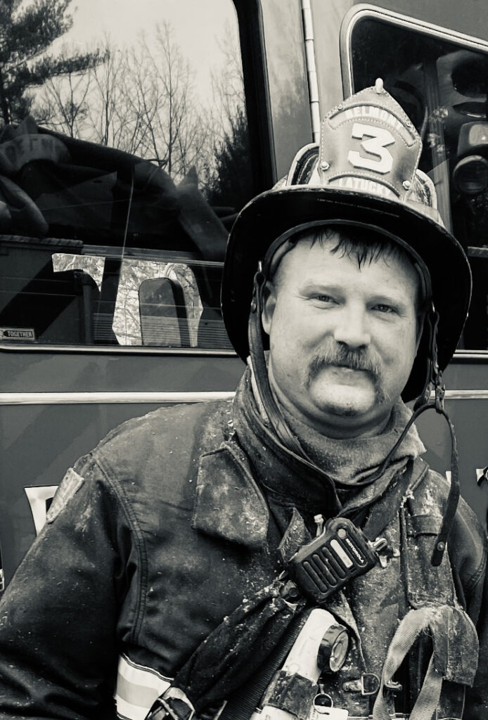 Firefighter in Front of Fire Truck