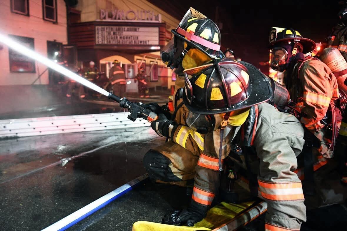 Firefighters Using Hose to Extinguish Fire